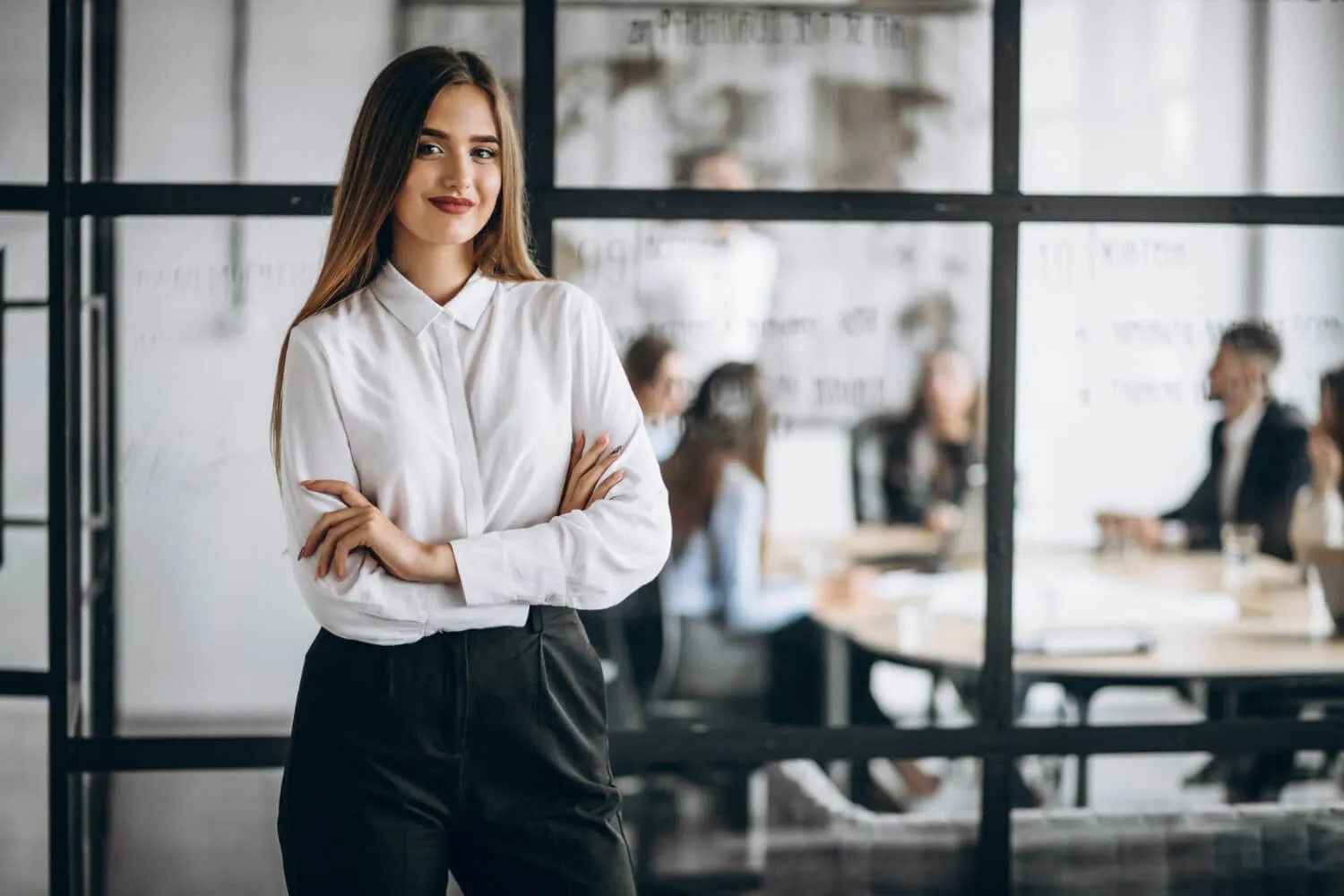 Smiling professional business woman in front of her team members